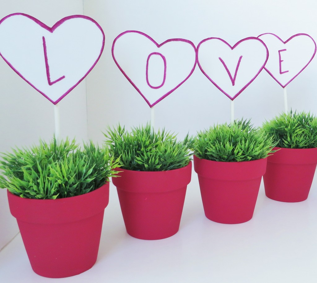 Step 7: Add the foam hearts  on a stick to the clay pots.