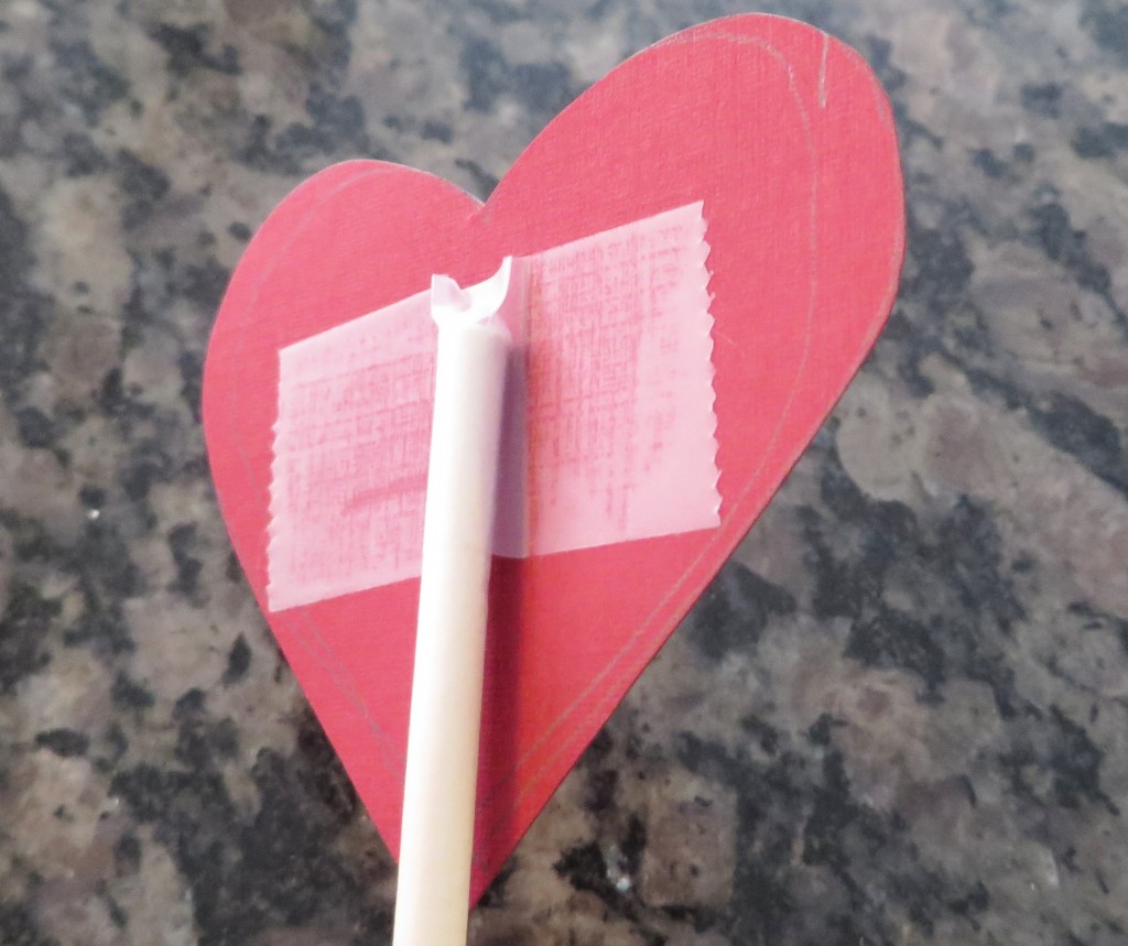 Step 5: Tape paper heart to the lollipop stick.