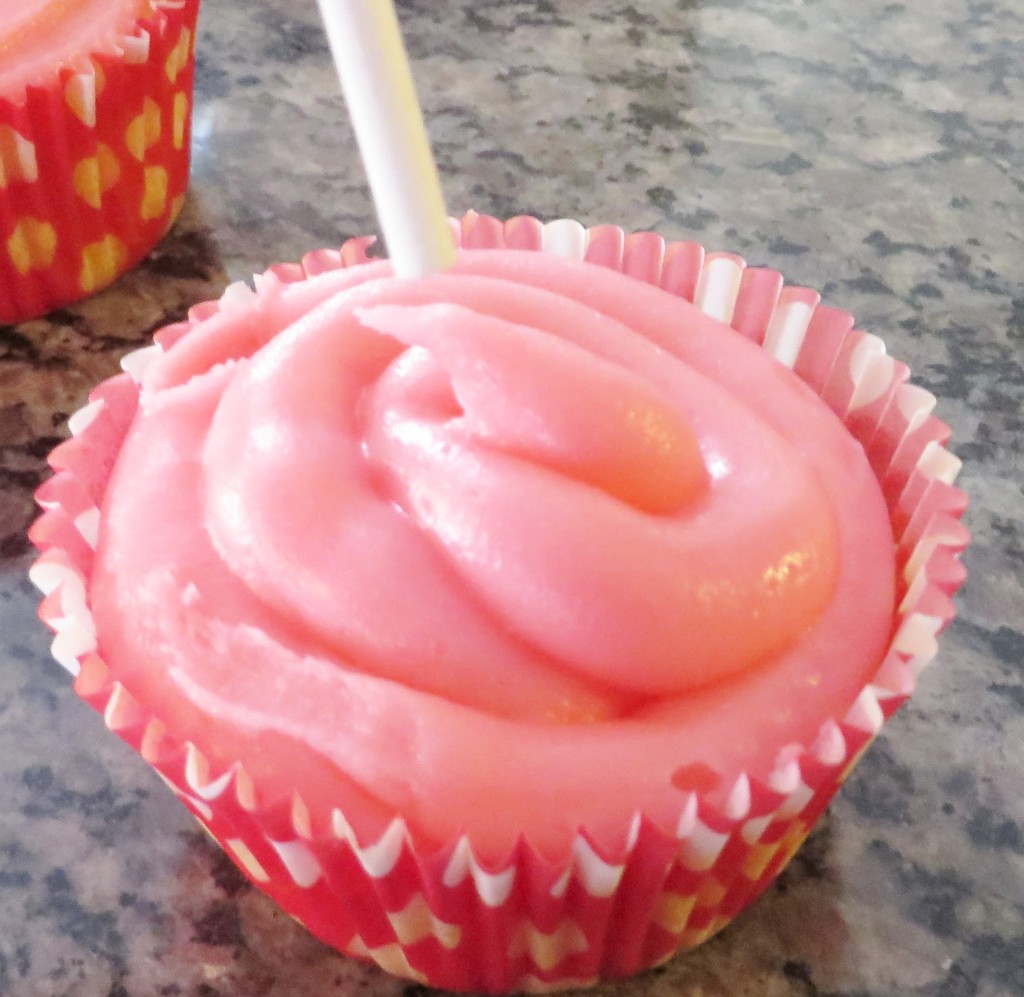 Step 7: Insert lollipop stick into the centre of the cupcake.